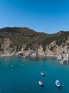 撒丁岛海岸线鸟瞰图与船和水晶般清澈的蓝色绿松石海图片