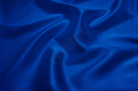 作为背景的蓝色缎子或丝绸织物图片