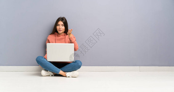 拿着笔记本电脑的年轻女学生背景图片
