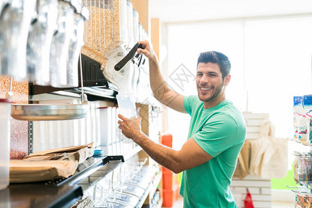 微笑的男子在超市大宗购买时在集装箱图片