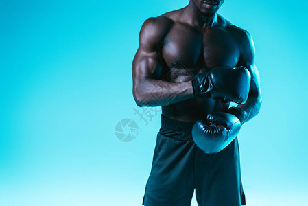 蓝底涂有肌肉躯体的非洲美式拳击图片
