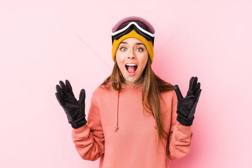 身穿滑雪衣的年轻高加索妇女孤立地受到一个令人愉快的惊喜兴奋图片