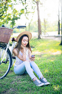 年轻女士在自然公园放松在花园的夏图片