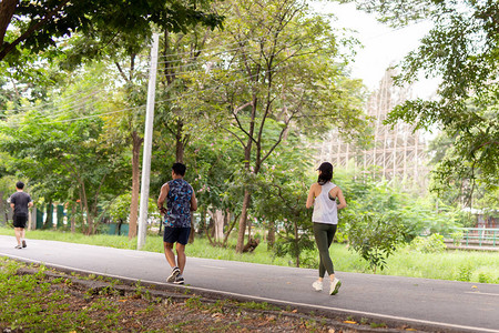 早上在公园的路上奔跑的男女运图片