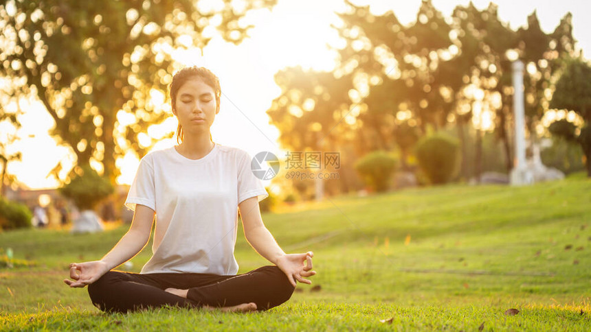 在公园里做瑜伽锻炼的漂亮亚洲女用于放松图片