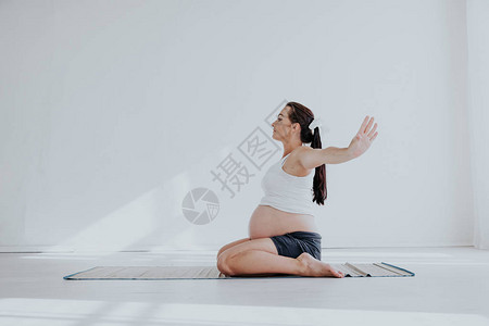一名孕妇从事体操和瑜伽分娩图片