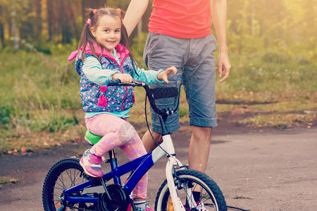 父亲教女儿骑自图片