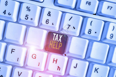 手写文本税务帮助对收入的强制贡献的概念照片援助白色pc键盘图片