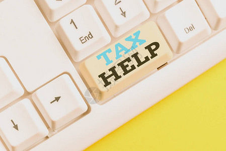 手写文本税务帮助对收入的强制贡献的概念照片援助白色pc键盘图片