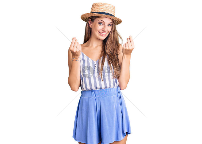身戴暑假帽子的年轻金发美女用双手做金钱姿态要求支付薪水图片