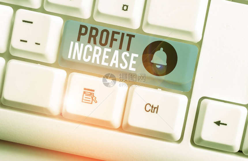 显示利润增加的文本符号商业照片展示了从商业白色pc键盘获得的收入增长图片