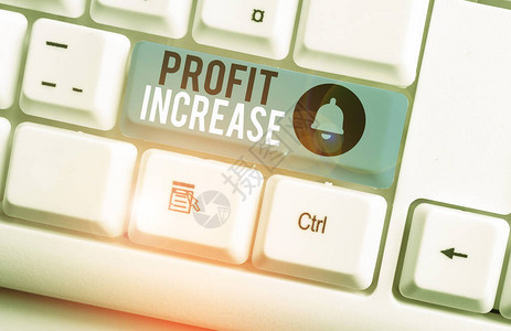 显示利润增加的文本符号商业照片展示了从商业白色pc键盘获得的收入增长图片