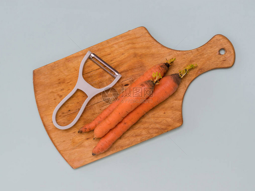 三根胡萝卜和一根削皮刀图片