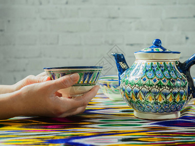 旅游者的手和传统的乌兹别克茶图片