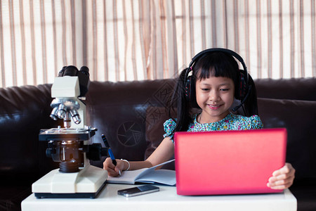 身戴耳机的亚洲女童在网上学习图片