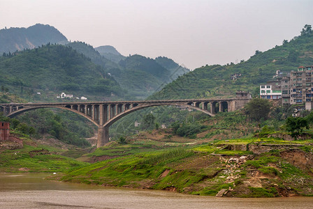 YangtzeRiver在森林山前的绿色海岸线上铺有双水泥横桥图片
