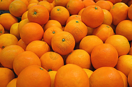 一堆鲜艳的颜色新鲜成熟的橘子为背景图片