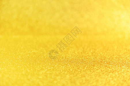 金色亮片关闭背景闪发光的黄色散焦背景迷人的金色沙粒图片