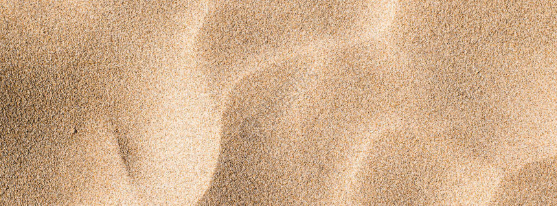 夏天沙滩上的沙子纹理特写作为背景图片
