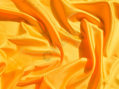 亮黄色丝绸有波浪移动背景抽象设计图片