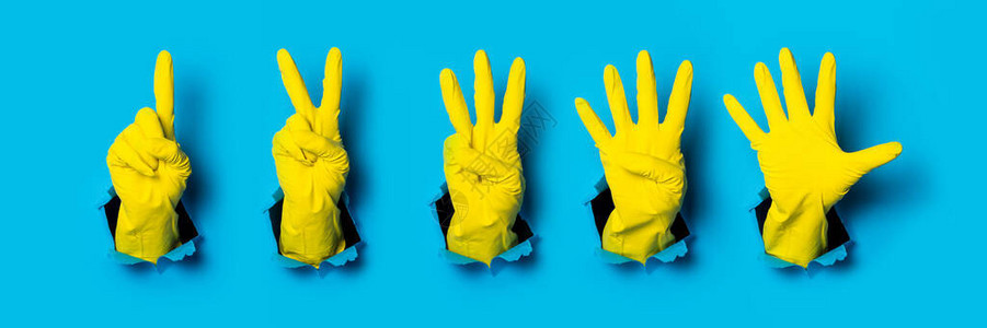 黄色手套上的双手显示12345个手指图片