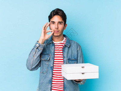 年轻caucasian男子拿着披萨图片