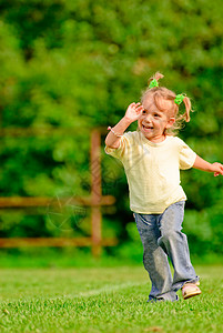 有尾巴的小女孩跑在绿图片