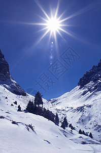 在冬天山的明亮的太阳图片