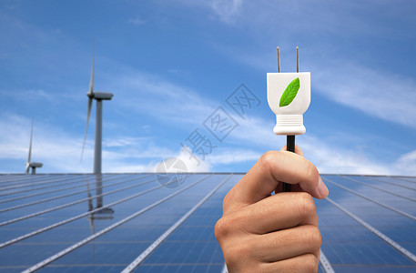 生态动力概念手持绿色电源插头太阳能电池板和风图片