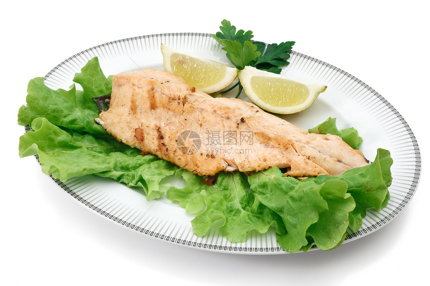 配有烤鲑鱼鳟生菜和柠檬的烧锅白背景图片