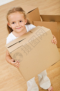 小女孩搬进新房子背着纸板盒图片