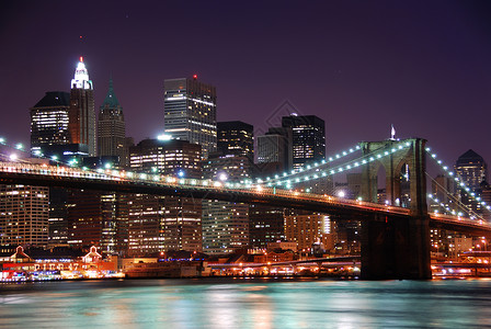 纽约市布鲁克林大桥和曼哈顿天际线哈德逊河上空有摩天大楼日落后黄图片