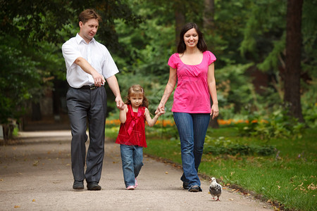 父母和女儿一起在夏日花园散步男人图片