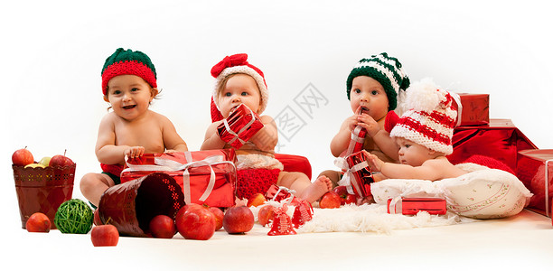 四个可爱的婴儿穿着Xmas服装图片