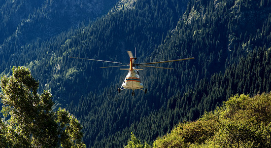 救援直升机在山上飞背景图片