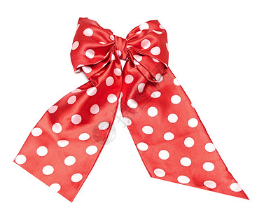 点缀在白色上的红色缎面礼品蝴蝶结和丝带图片