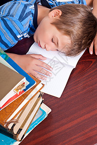 年轻孩子在做功课在辛苦学习一天后睡图片