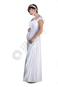 美丽的怀孕新娘穿着婚纱隔图片