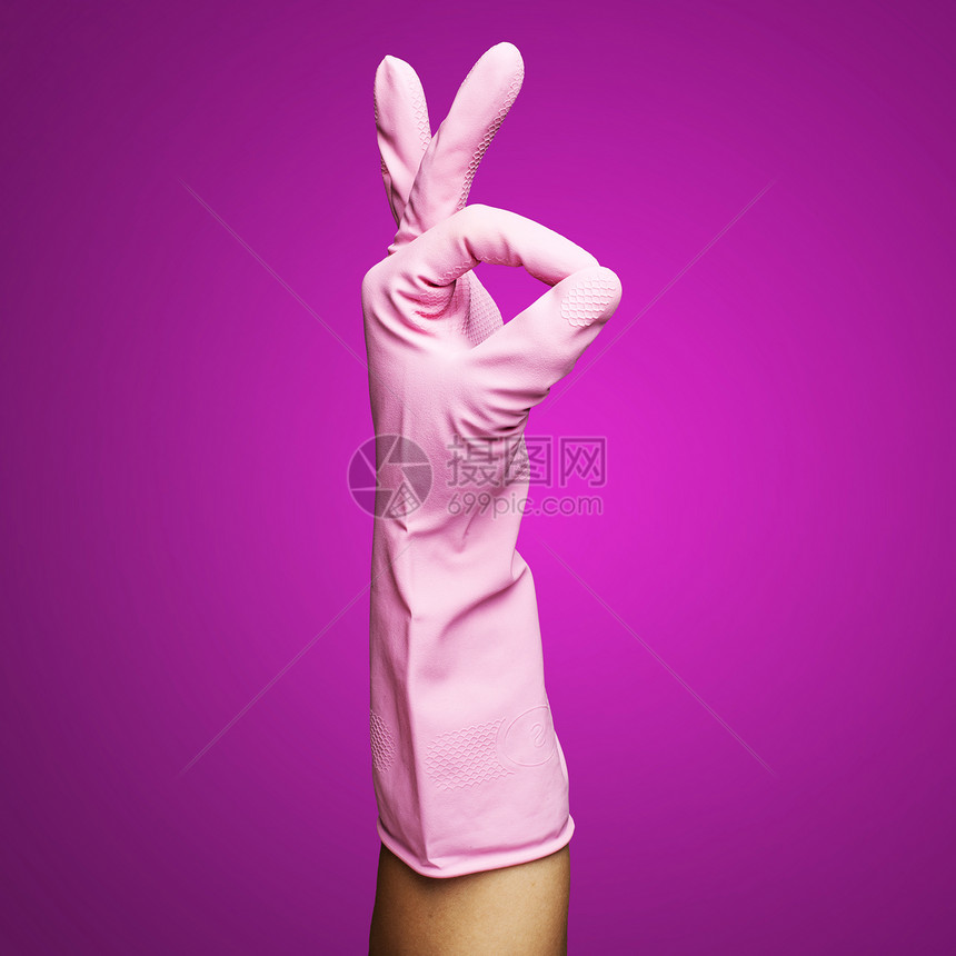 粉红色橡胶手套在粉红背图片