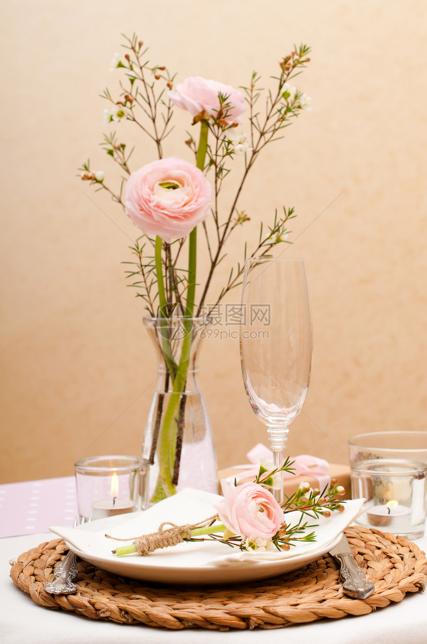 用粉色鲜花和蜡烛布置的节日餐桌图片