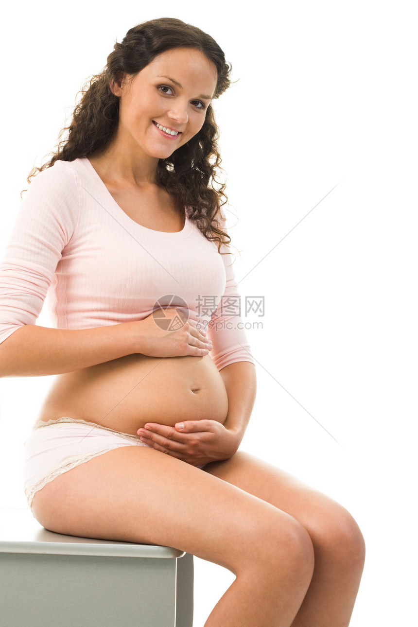 相片照美丽的孕妇坐在肚子上图片
