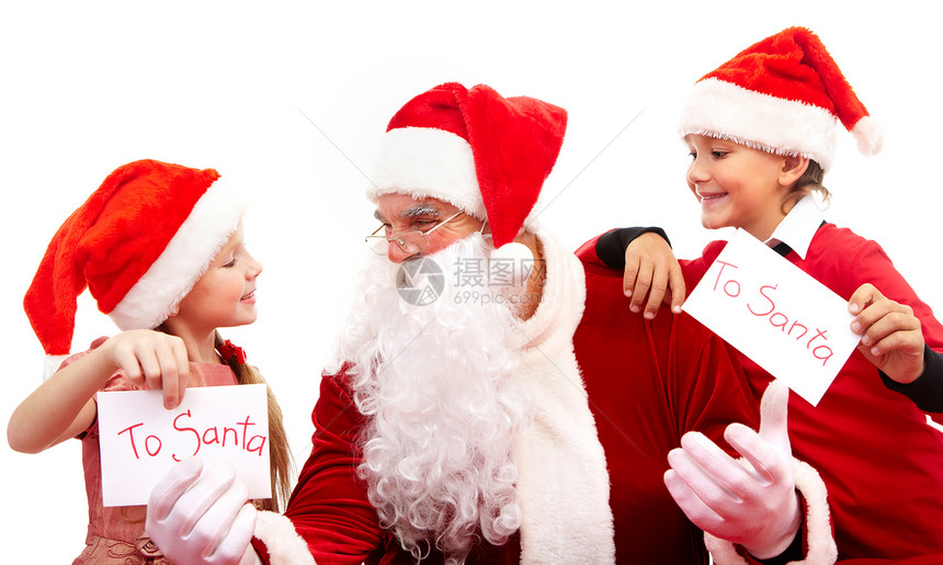 圣诞老人在小男孩与女孩之间给他写图片