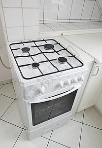 白色瓷砖厨房里的白色燃气灶图片