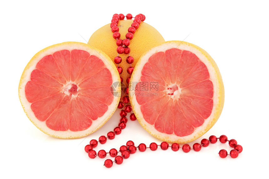 红宝石红葡萄柚整体和一半与串珠在白色背景图片