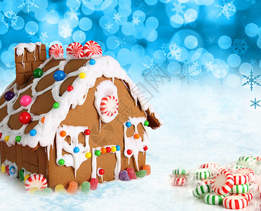 欢乐圣诞节雪背景的姜饼屋图片
