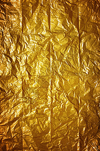 旧皱折的黄色包装纸的闪亮背景图片