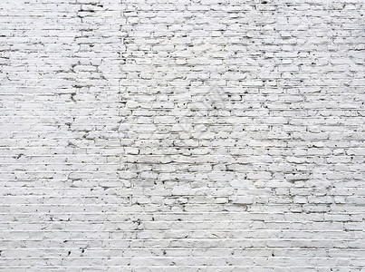 破裂的白色砖墙背景图片