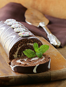 木板上的香草奶油巧克力蛋糕卷图片