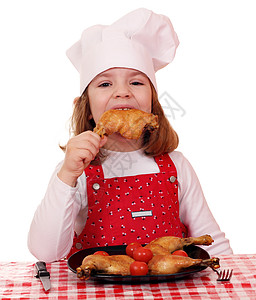 饥饿的小女孩厨师吃鸡腿图片
