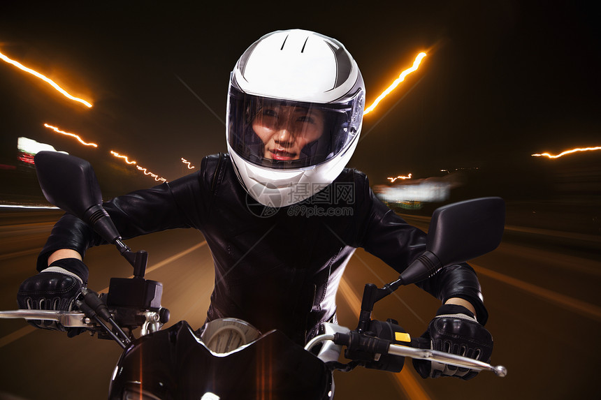 年轻女子骑摩托车穿过北京街头有轻图片
